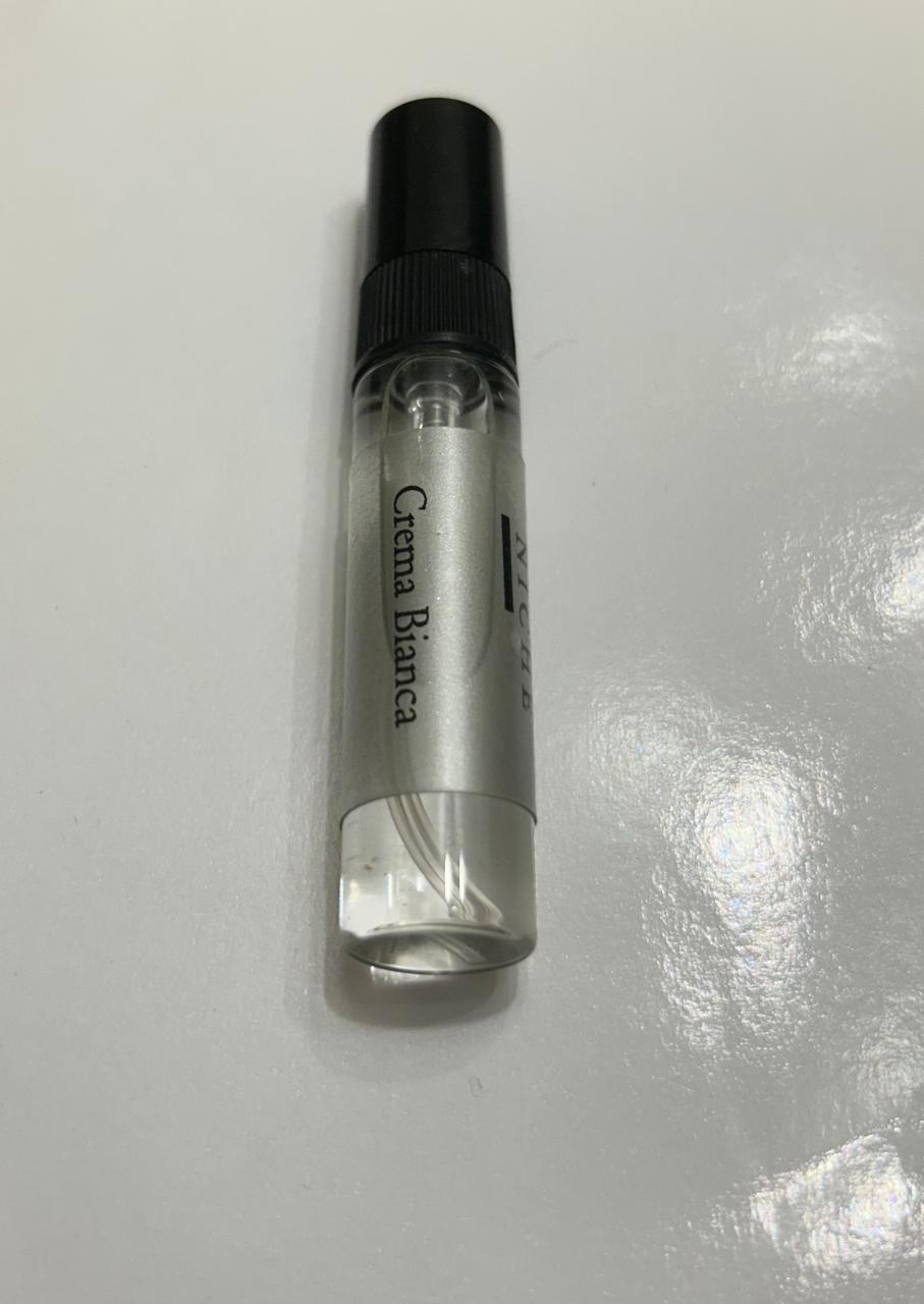 Small clear bottle with black cap labeled 'Crema Bianca' on a white background